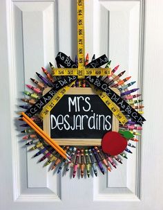 a wreath made out of colored pencils and rulers with the words mrs dessardins written on it