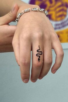 a person's hand with a tattoo on it and the word love written in cursive writing