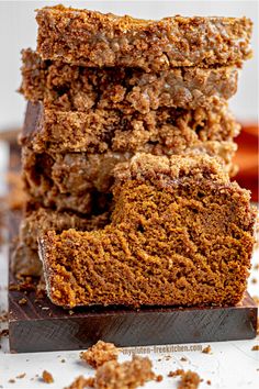 a stack of brownies sitting on top of a cutting board next to each other