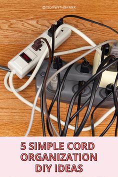 an electrical outlet with wires and cords connected to it on top of a wooden table