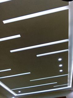 the ceiling is covered with white lights and strips of light coming from it's sides