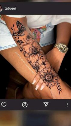 a woman's arm with flowers and butterflies on it