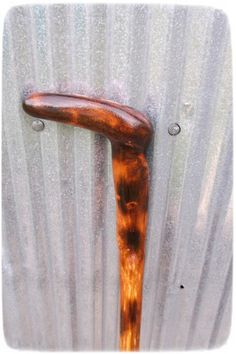 a wooden handle on the side of a metal container