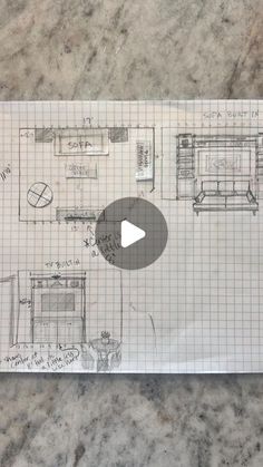 a piece of paper with a drawing of a kitchen and living room on top of it