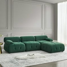 a green couch sitting on top of a white rug