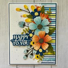 a close up of a greeting card with flowers on the front and bottom, which says happy birthday to you