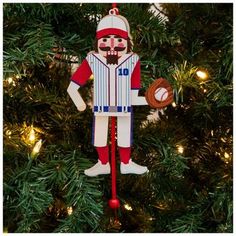 a baseball ornament hanging from a christmas tree