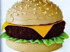 a hamburger made out of chocolate frosting and sprinkled with sesame seeds on top