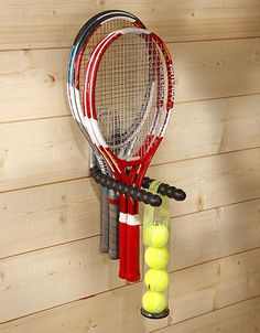 a racket and tennis balls hanging on a wall