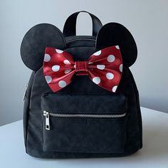 New Disney Minnie Mouse Mini, Faux Suede Backpack, With Metallic Red Bow. The Softest Faux Suede On The Exterior With The Classic Minnie Mouse Bow. Silver Accents On The Hardware. Adjustable Straps On The Back. Smoke Free And Pet Free Home. Minnie Mouse Backpack For Daily Use, Cute Mickey Mouse Bags For Gifts, Cute Mickey Mouse Bags As Gift, Trendy Minnie Mouse Travel Backpack, Trendy Minnie Mouse Backpack For Travel, Black Minnie Mouse Backpack For Everyday Use, Black Minnie Mouse Backpack For Back To School, Black Minnie Mouse Bag For Back To School, Minnie Mouse Backpack For Disney Fan Events