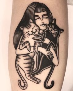 a woman holding a cat on her arm with another cat in the other arm behind her