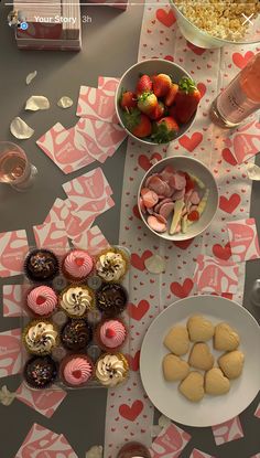 a table topped with lots of different types of desserts and pastries next to wine glasses