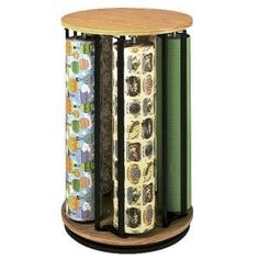 three rolls of wrapping paper are stacked on a wooden stand with two different colored tapes