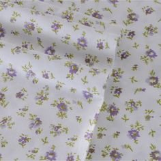 purple and green flowers on white fabric