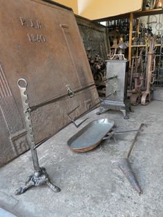 an old metal chair sitting on top of a floor next to a pile of junk