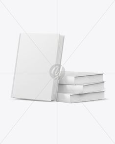 a stack of white books sitting next to each other on top of a white surface