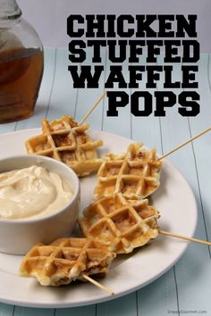 chicken stuffed waffle pops on a white plate with a bowl of ranch dressing in the background