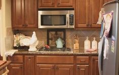 a kitchen with wooden cabinets and stainless steel appliances, including a microwave above the stove