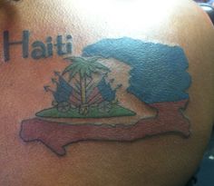 a man with a tattoo on his back that says haiti and has an island in the middle