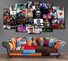 a couch sitting in front of a wall with pictures on the back and one side