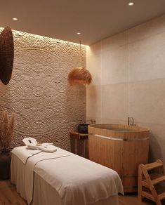 a spa room with a jacuzzi tub and towels on the table next to it