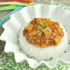 a white plate topped with rice and meat