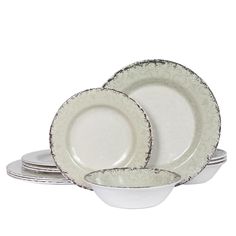 a set of four white dishes sitting on top of each other