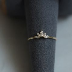 a diamond ring sitting on top of a black cloth