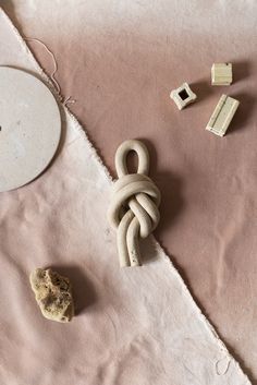 an object is laying on the ground next to some beads and other items that are scattered around it