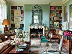 a living room filled with furniture and lots of books