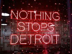 a neon sign that says nothing stops detroit