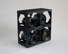 four cameras are stacked on top of each other in a square shape, with the lens section facing upwards