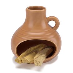 a brown vase sitting on top of a white table