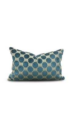 a blue and white pillow on a white background