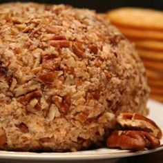 a close up of a plate of food with nuts on it and crackers in the background