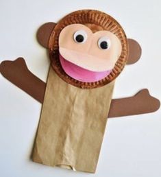 a paper bag with a monkey made out of it's mouth and hands on top