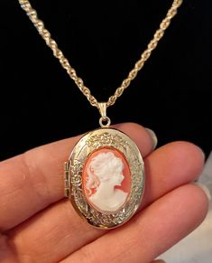 Vintage victorian style cameo necklace. Necklace is gold tone with resign cameo set on floral etched gold tone locket. Preowned Elegant Luxury Cameo Necklace, Cheap Vintage Necklace With Oval Pendant, Victorian Cameo Necklace, Costume Jewelry Medallion Locket Necklace, Antique Cameo Medallion Jewelry, Vintage Gold-tone Locket Necklaces, Costume Jewelry Round Pendant Locket Necklace, Costume Jewelry Necklace With Round Locket Pendant, Costume Jewelry Necklace With Locket Pendant