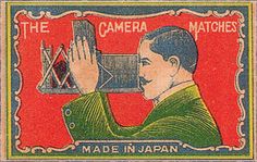 an old stamp with a man holding up a camera