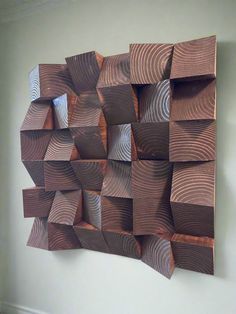 a wooden sculpture is hanging on the wall