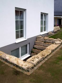 a white house with stone steps leading up to it