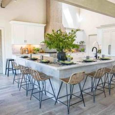 a large kitchen with an island and bar stools