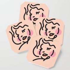 four pink coasters with black and white faces on them