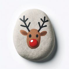 a rock with a reindeer's face painted on it