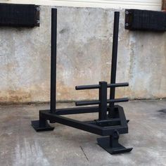 a pair of squat stands in front of a concrete wall with black bars on it