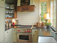 a stove top oven sitting inside of a kitchen