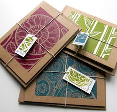 four cards with tags attached to them sitting on top of each other, all decorated in different patterns