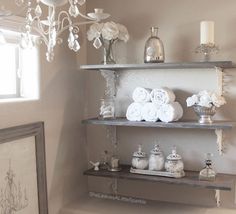 shelves with towels and candles in a bathroom