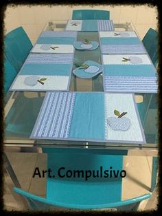 a glass table with blue chairs and place mats