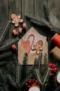 an envelope with cookies, candy canes and christmas decorations on it next to candles