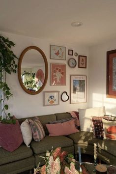 a living room filled with lots of furniture and pictures on the wall above it's coffee table